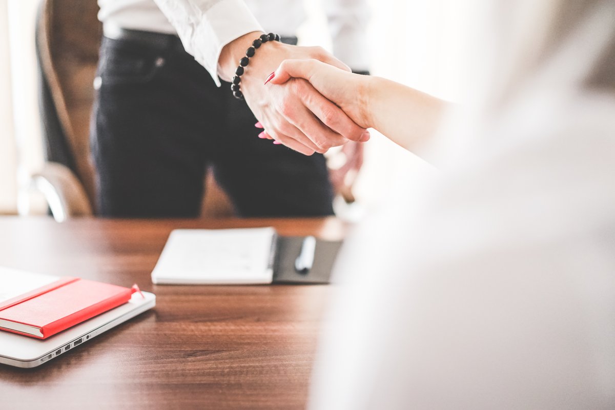 Two business partners shaking hands in an office